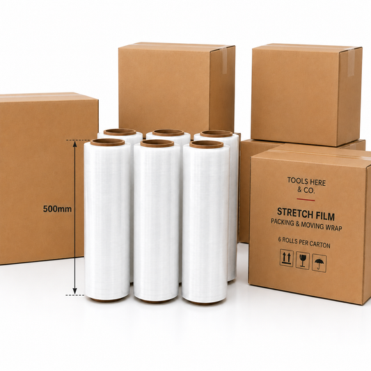 Six rolls of clear stretch film in brown cardboard boxes, with a dimension marker indicating 500mm width. The boxes are branded 'TOOLS HERE & CO.